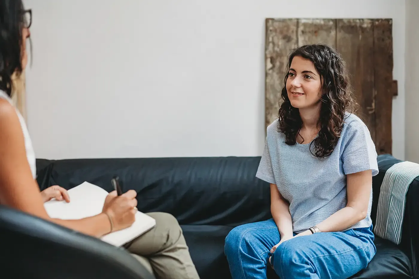 Photo of a psychotherapy session, woman talking to their psychologist