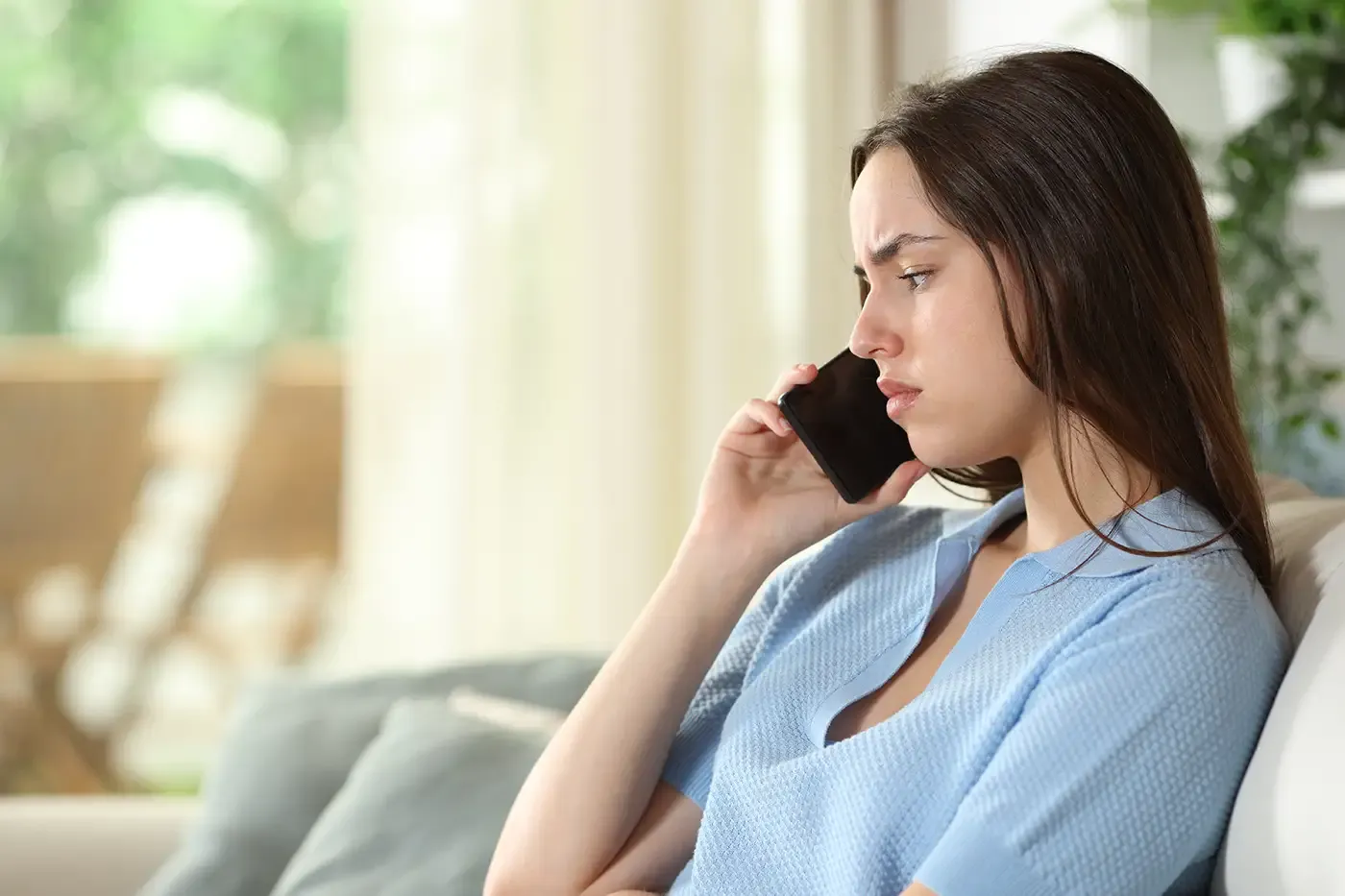 Photo of a woman at home talking on phone