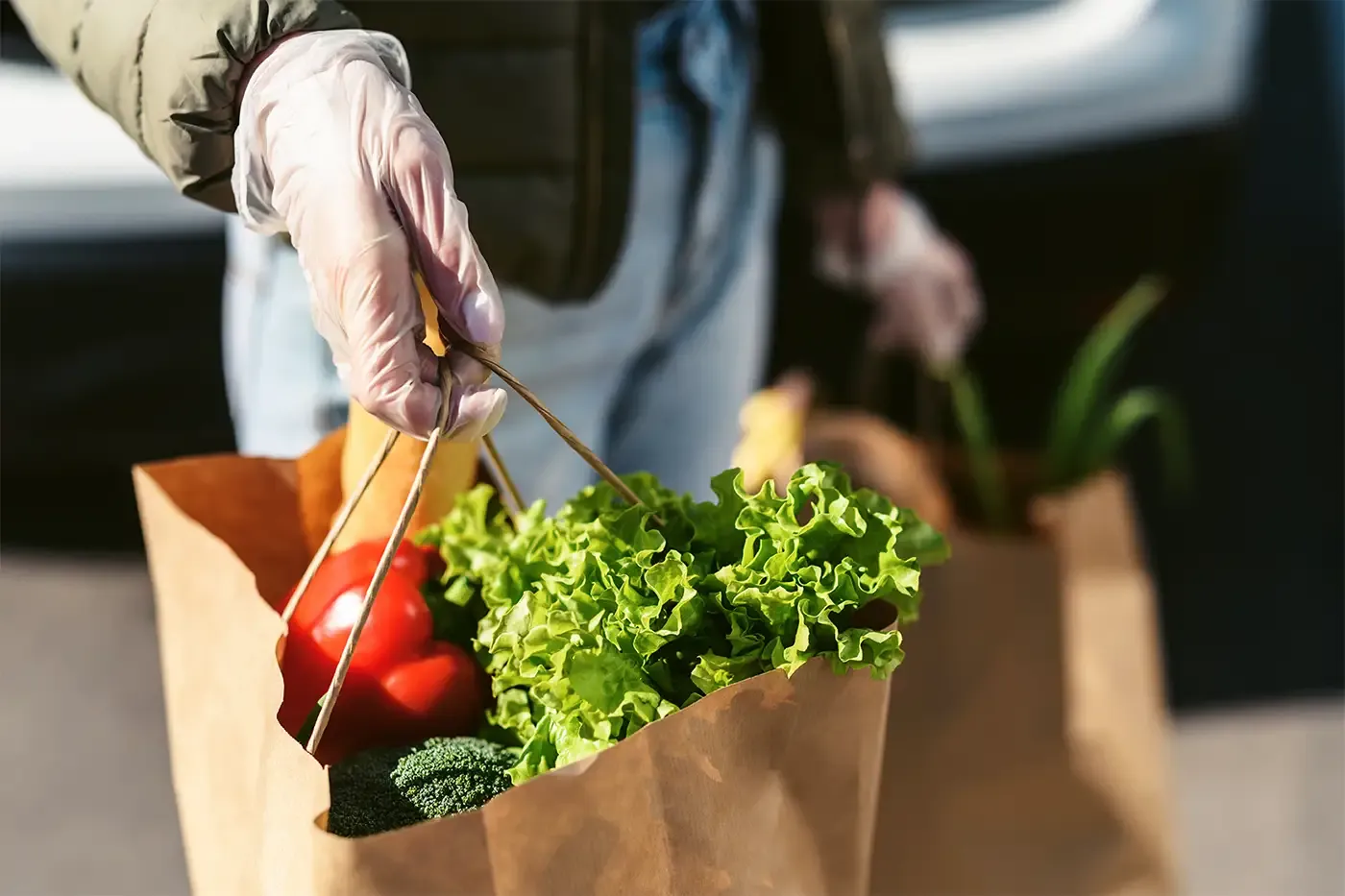 Volunteer delivering groceries and essential supplies to support survivors staying at Hilltop's Latimer House emergency safehouse.